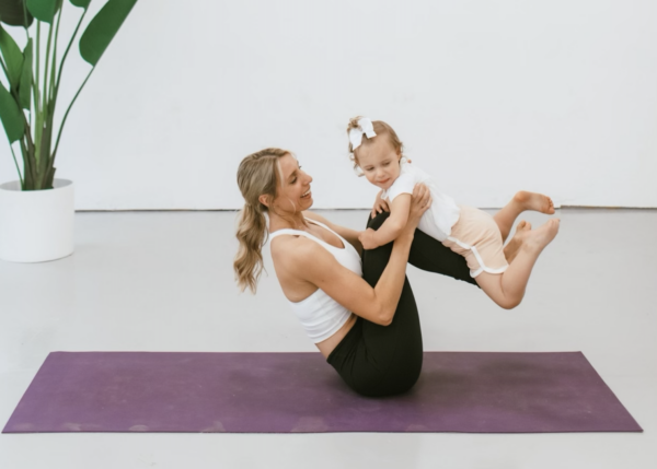 Melissa with her daughter doing yoga